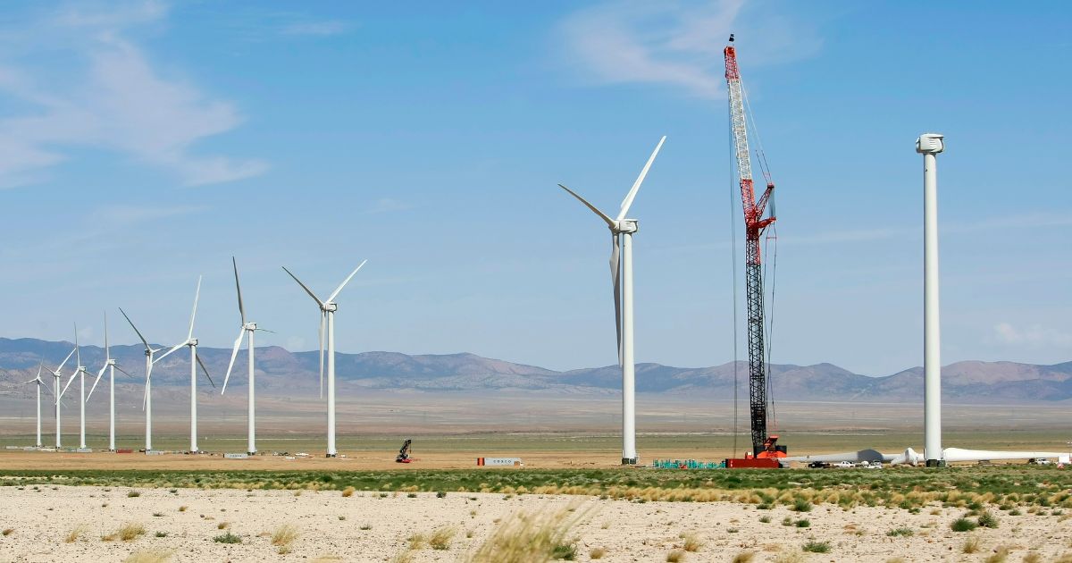 A large crane works on one of several 300 foot tall wind powered generators being built at WindConnect's Milford Wind Corridor Project July 15, 2009 just north of Milford, Utah.
